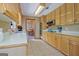 A traditional-style kitchen offers tile floors, lots of cabinet space, and bright, natural light at 351 Weldon Rd, Palmetto, GA 30268