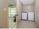 Clean laundry room featuring modern washer and dryer set and an entrance to the garage at 351 Weldon Rd, Palmetto, GA 30268