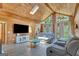 Wood paneled living room with vaulted ceilings, a skylight, large windows, and a ceiling fan at 351 Weldon Rd, Palmetto, GA 30268