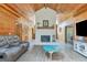 The living room features a stone fireplace and wood paneled walls and vaulted ceilings at 351 Weldon Rd, Palmetto, GA 30268