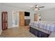 This main bedroom features wood floors, a ceiling fan, and an en suite bathroom at 351 Weldon Rd, Palmetto, GA 30268