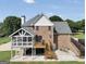 View of the backyard of the brick home, featuring a screened porch and wooden deck at 106 Big Cotton Trl, Mcdonough, GA 30252