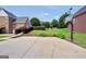 Spacious backyard featuring a basketball court, lush lawn, and mature landscaping, great for outdoor activities and entertaining at 106 Big Cotton Trl, Mcdonough, GA 30252