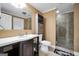 Well-lit bathroom with a vanity, built in cabinet, and a shower with glass doors at 106 Big Cotton Trl, Mcdonough, GA 30252