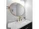 Stylish powder room features a marble countertop, a gold faucet, and a decorative, round mirror at 106 Big Cotton Trl, Mcdonough, GA 30252