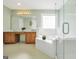 Large bathroom offers a tub with tile surround, a glass shower, and double sink vanities at 106 Big Cotton Trl, Mcdonough, GA 30252