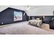 Spacious bedroom featuring a dark accent wall, a large window, and neutral carpeting at 106 Big Cotton Trl, Mcdonough, GA 30252