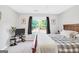Bright bedroom with a queen size bed, plush carpet, and a window overlooking the front yard at 106 Big Cotton Trl, Mcdonough, GA 30252
