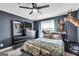 Inviting bedroom featuring a camo comforter, a black ceiling fan and a large window at 106 Big Cotton Trl, Mcdonough, GA 30252