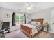 Well-lit bedroom features hardwood floors and gray walls with black-out curtains at 106 Big Cotton Trl, Mcdonough, GA 30252
