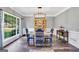 Classic dining room with a large window, dark wood floors, and a charming display cabinet at 106 Big Cotton Trl, Mcdonough, GA 30252