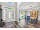 Elegant dining area with stylish lighting, wood floors, and a view of the front yard at 106 Big Cotton Trl, Mcdonough, GA 30252