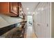 Stylish galley kitchen with dark granite countertops, wood cabinets, and stainless steel microwave at 106 Big Cotton Trl, Mcdonough, GA 30252