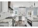 Bright kitchen boasts granite countertops, stainless appliances, white cabinets, and hardwood floors at 106 Big Cotton Trl, Mcdonough, GA 30252