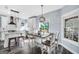 Eat-in kitchen features stainless appliances, white cabinets, and modern lighting at 106 Big Cotton Trl, Mcdonough, GA 30252