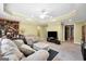 Spacious living room features a comfortable sectional sofa, wall-mounted TV, and unique yellow ceiling at 106 Big Cotton Trl, Mcdonough, GA 30252