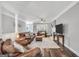 Inviting living room featuring leather furniture, a cozy fireplace, and ample natural light at 106 Big Cotton Trl, Mcdonough, GA 30252