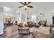 Open concept: Living room flows into the dining area, with wood floors throughout at 106 Big Cotton Trl, Mcdonough, GA 30252