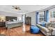 Spacious main bedroom with hardwood floors, a tray ceiling, and large windows with blue curtains at 106 Big Cotton Trl, Mcdonough, GA 30252