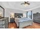 The hardwood-floored main bedroom has a tray ceiling, large windows and rustic-look furniture at 106 Big Cotton Trl, Mcdonough, GA 30252
