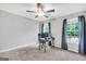 Minimalist home office space with desk, chair, and large windows for natural light, set on neutral carpet at 106 Big Cotton Trl, Mcdonough, GA 30252