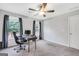 Bright home office with neutral walls, a dark desk setup and plenty of natural light from two windows at 106 Big Cotton Trl, Mcdonough, GA 30252