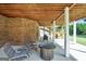 Comfortable outdoor space with patio furniture, great for entertaining, located under a raised wooden deck with brick support at 106 Big Cotton Trl, Mcdonough, GA 30252
