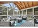 Relaxing sunroom features vaulted wood ceilings, screened windows, and a comfortable seating area at 106 Big Cotton Trl, Mcdonough, GA 30252