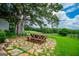 Outdoor dining area with a picnic table and stone patio, perfect for entertaining at 1074 Glenloch Rd, Roopville, GA 30170
