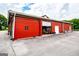 Side of the red barn with 'No Smoking' sign and open garage style doors at 1074 Glenloch Rd, Roopville, GA 30170