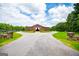 Large barn with a long driveway, lush lawn, and mature trees at 1074 Glenloch Rd, Roopville, GA 30170