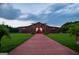 Exterior of charming barn venue with decorative lighting, walkway, and landscaped planters at 1074 Glenloch Rd, Roopville, GA 30170