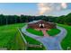 Stunning barn with white curtains and landscaping welcomes visitors to Venue 1074 at 1074 Glenloch Rd, Roopville, GA 30170