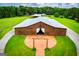Brown barn with open doors, a landscaped entrance, and a circular driveway leading to it at 1074 Glenloch Rd, Roopville, GA 30170