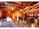 Spacious barn event space with tables, chairs, wood paneling and concrete floors at 1074 Glenloch Rd, Roopville, GA 30170