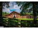 Barn's exterior framed by trees and wooden fence has large entry with white drapes at 1074 Glenloch Rd, Roopville, GA 30170