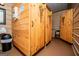 Bathroom stall area with light colored wood walls and wooden doors at 1074 Glenloch Rd, Roopville, GA 30170