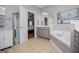 Elegant bathroom featuring a soaking tub, vanity, and tiled flooring, perfect for relaxation at 1074 Glenloch Rd, Roopville, GA 30170