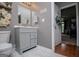 Bathroom showcasing gray vanity, white toilet, and patterned tile flooring at 1074 Glenloch Rd, Roopville, GA 30170