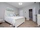Comfortable bedroom with neutral paint, modern lighting, and a white bed set at 1074 Glenloch Rd, Roopville, GA 30170