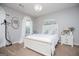 Cozy bedroom with white furniture, soft lighting, and large window at 1074 Glenloch Rd, Roopville, GA 30170