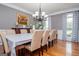 Traditional dining room features a chandelier, hardwood floors, and a long table with seating for ten at 1074 Glenloch Rd, Roopville, GA 30170