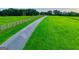 Gated driveway leads to this country estate with fencing and green pastures, perfect for horses at 1074 Glenloch Rd, Roopville, GA 30170