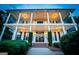 Stately two-story white home with large columns, black doors and shutters, and manicured landscaping at 1074 Glenloch Rd, Roopville, GA 30170