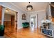 Stately entryway with hardwood floors, a dark green sofa, and formal decor at 1074 Glenloch Rd, Roopville, GA 30170