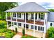 Stately two-story home with a second-floor balcony and manicured landscaping at 1074 Glenloch Rd, Roopville, GA 30170