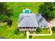 Aerial view of the elegant home with a pool surrounded by lush landscaping at 1074 Glenloch Rd, Roopville, GA 30170