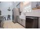 Well-lit kitchen with stainless steel appliances, shaker cabinets, and tile flooring at 1074 Glenloch Rd, Roopville, GA 30170