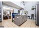Open kitchen with island, tile flooring and stainless steel appliances at 1074 Glenloch Rd, Roopville, GA 30170