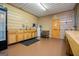 This commercial kitchen features wood cabinets, double sink, refrigerator, exterior door and hot water heater at 1074 Glenloch Rd, Roopville, GA 30170